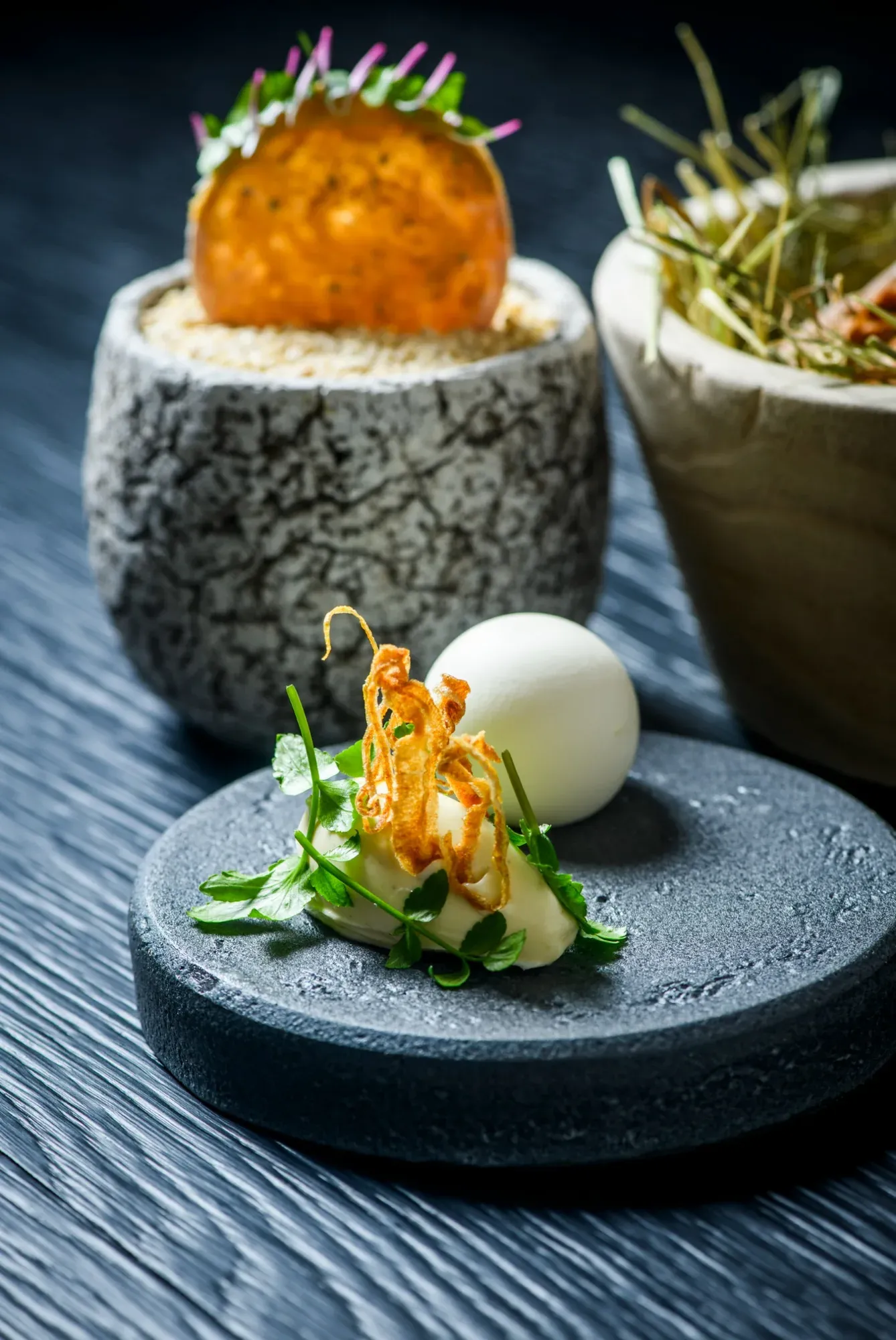 An amuse-bouche from the Chef's Table by Gesser served on stone and in a ceramic bowl