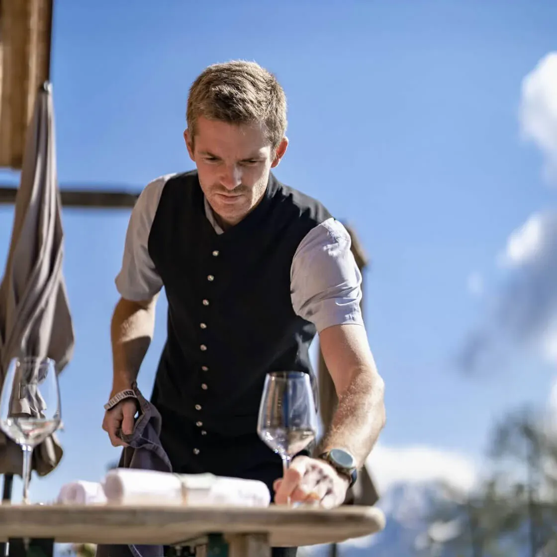 Markus Gesser, maître of the Chef's Table by Gesser, pouring wine on the terrace