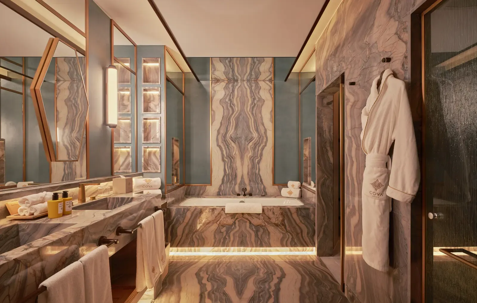 The marble bathroom of the COYA Suite Marbella with a bathtub and double vanity
