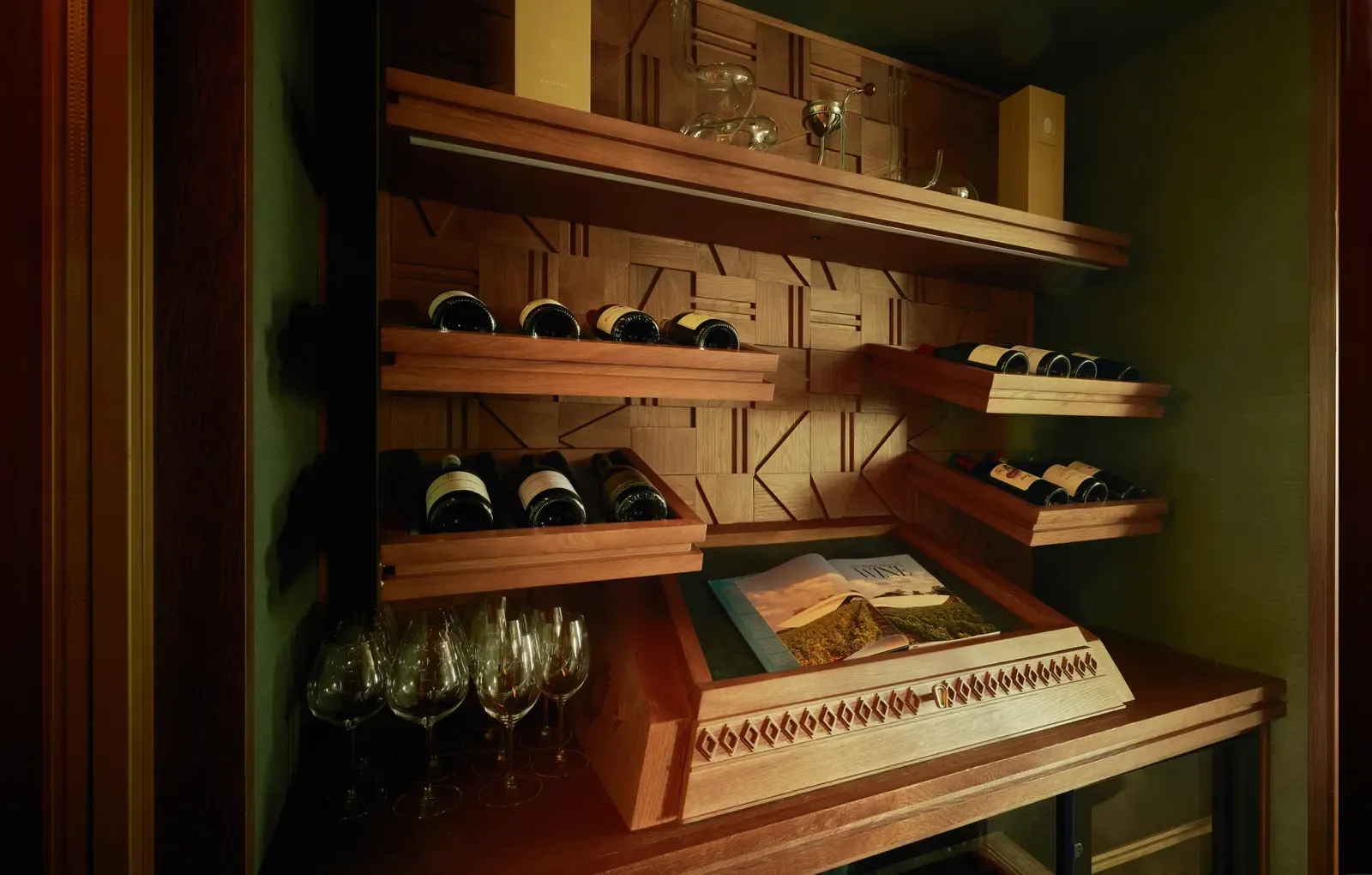 Shelves with bottles and glasses in the cellar of the COYA Suite Marbella