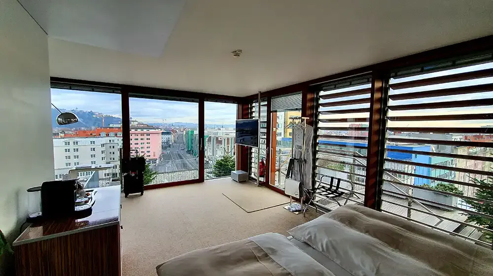 Bedroom of the LoftCube with a view over Graz
