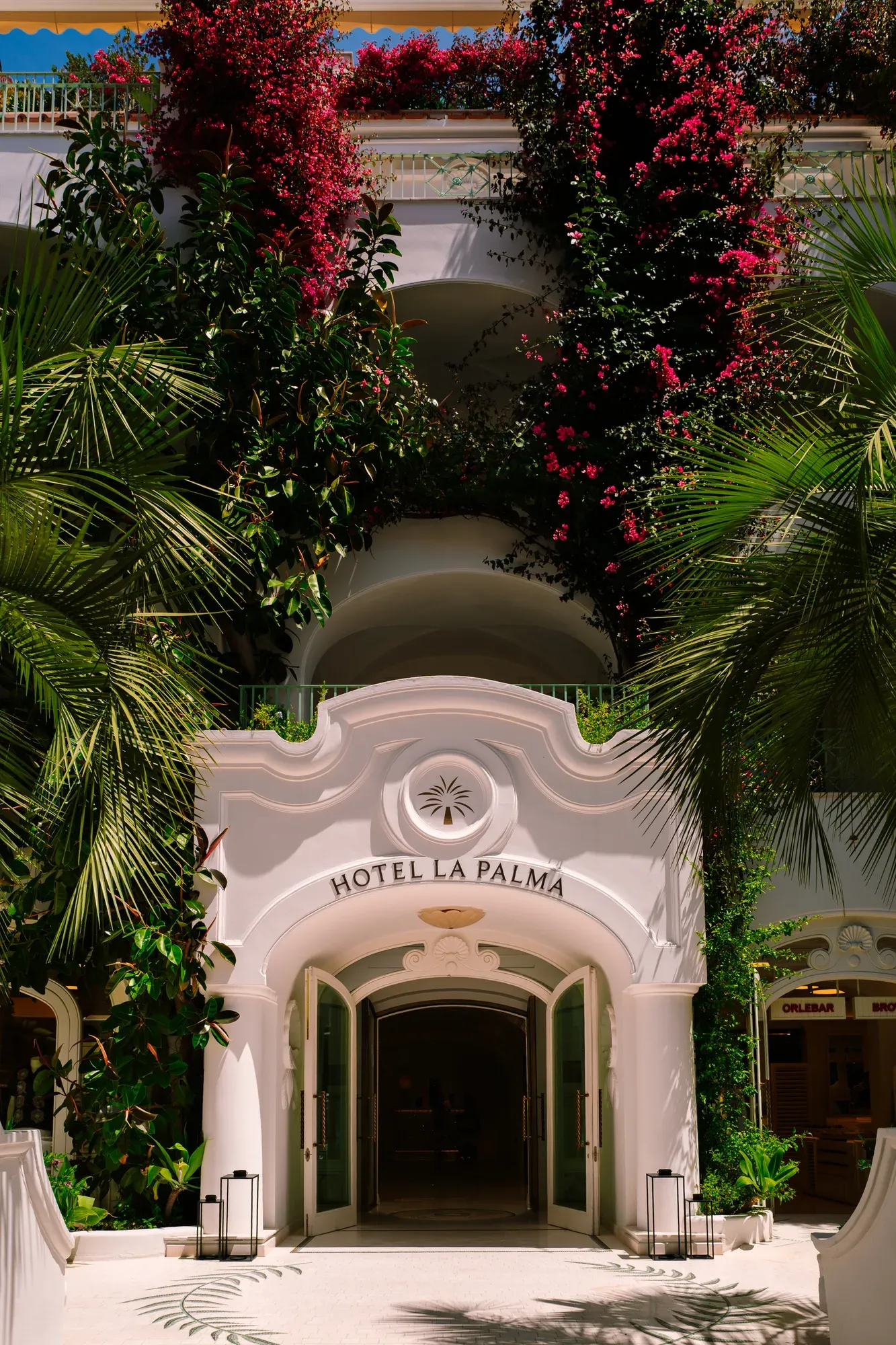 The entrance of Hotel La Palma on Capri, framed by bougainvillea and palms