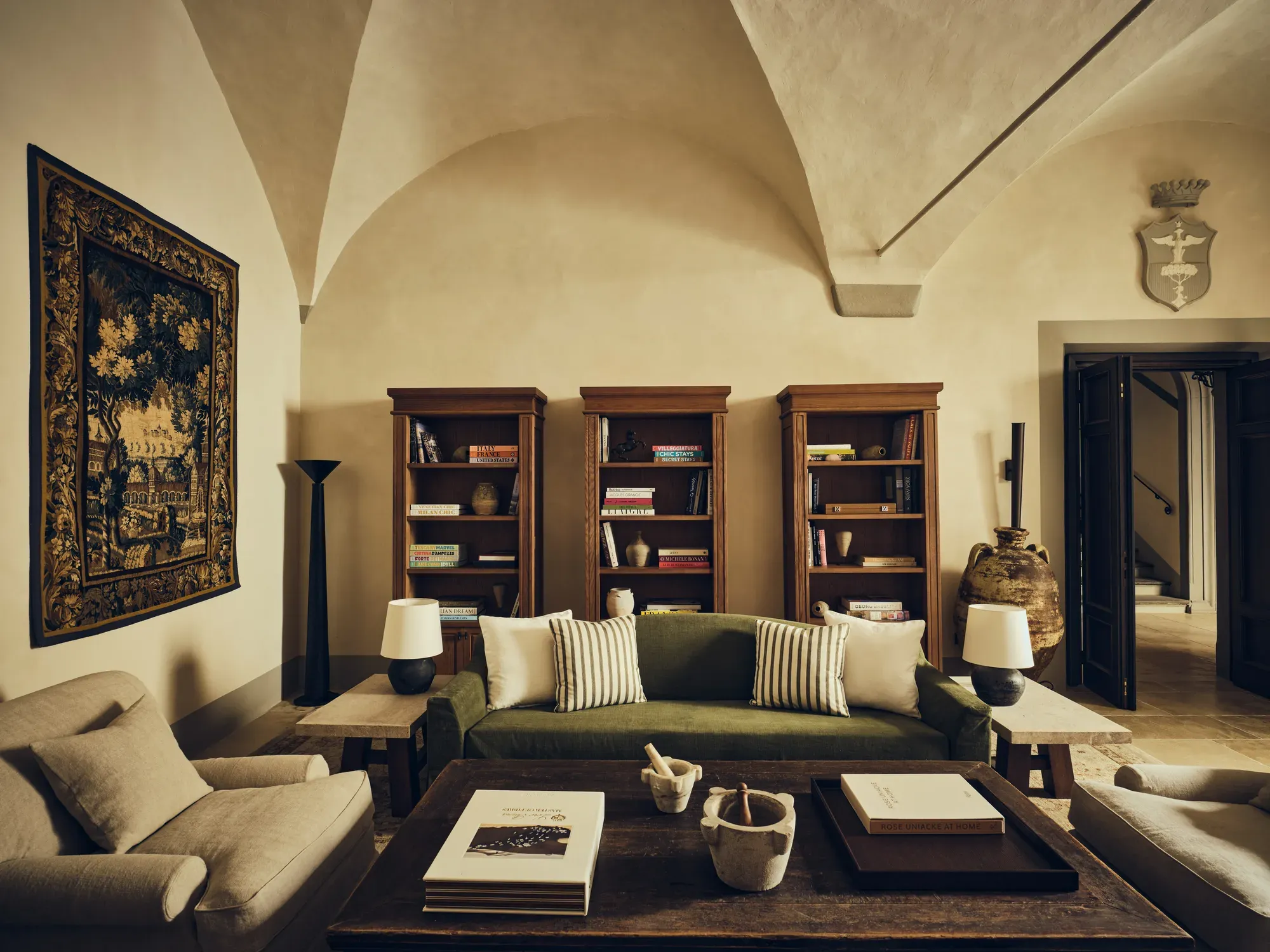 The salon of La Réserve Firenze with a tapestry and sofas