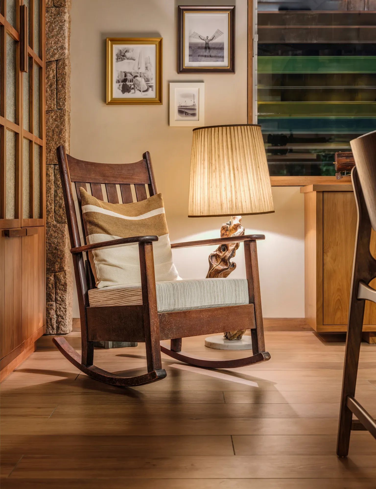 A rocking chair and a reading lamp in a villa at La Réserve Seychelles