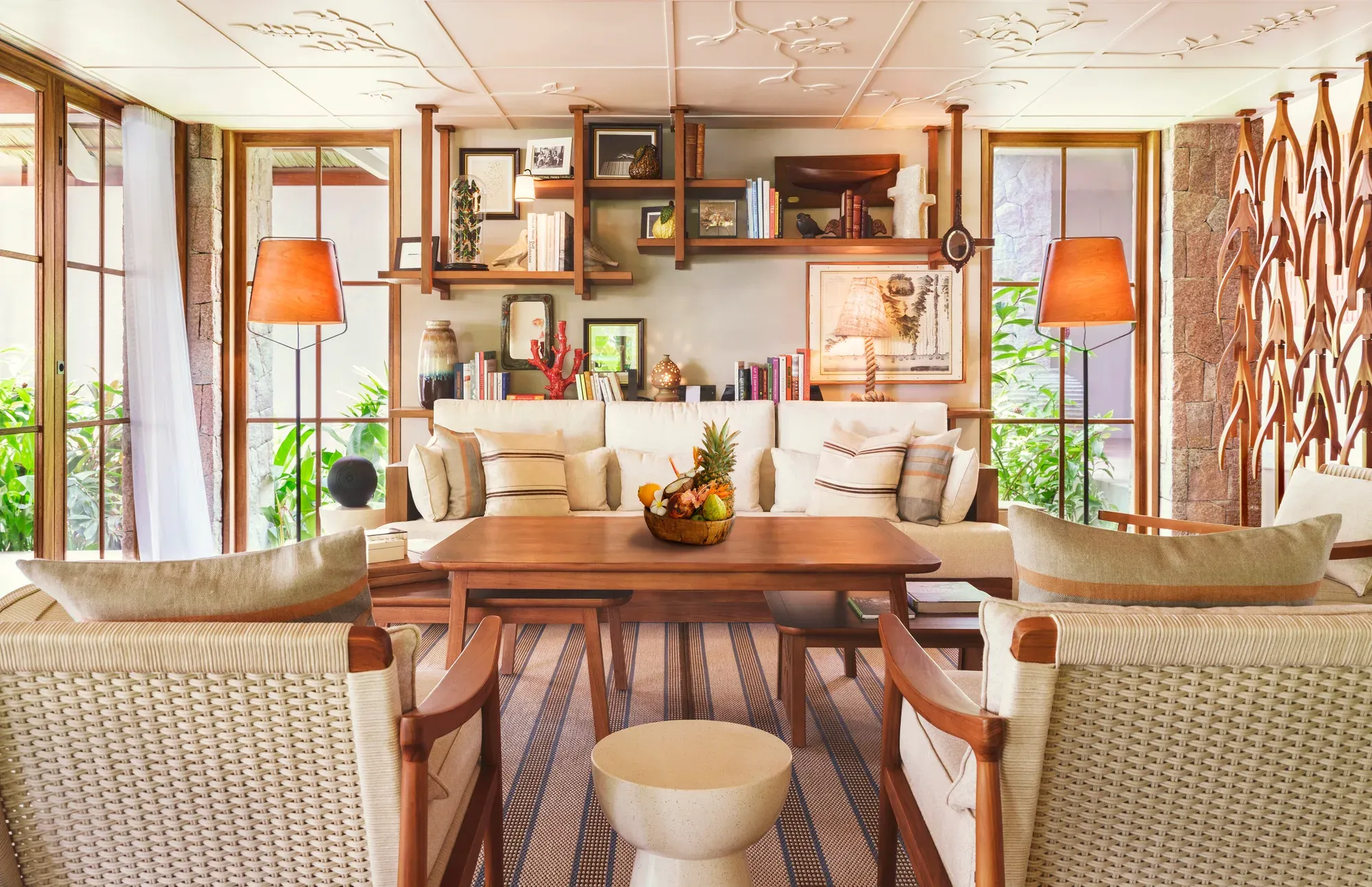 The open-plan living room of a villa at La Réserve Seychelles, with wooden floors and a dining table