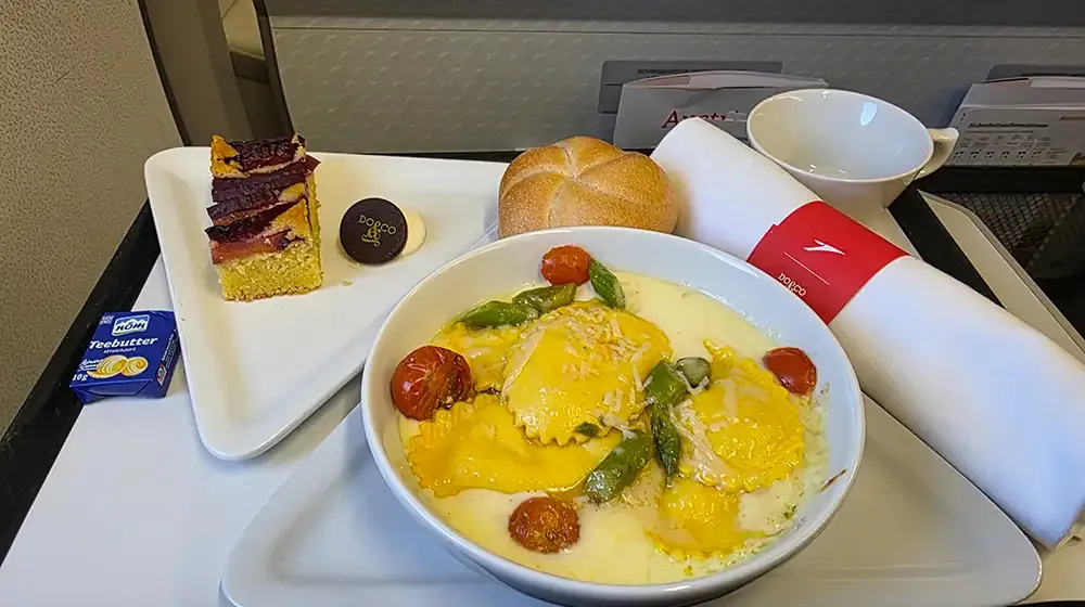 Austrian Airlines Business Class meal with ravioli and dessert