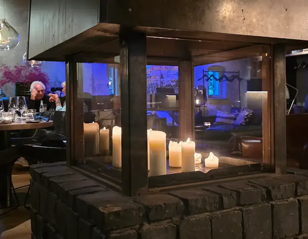 Open fireplace with candles at Hygge Hamburg