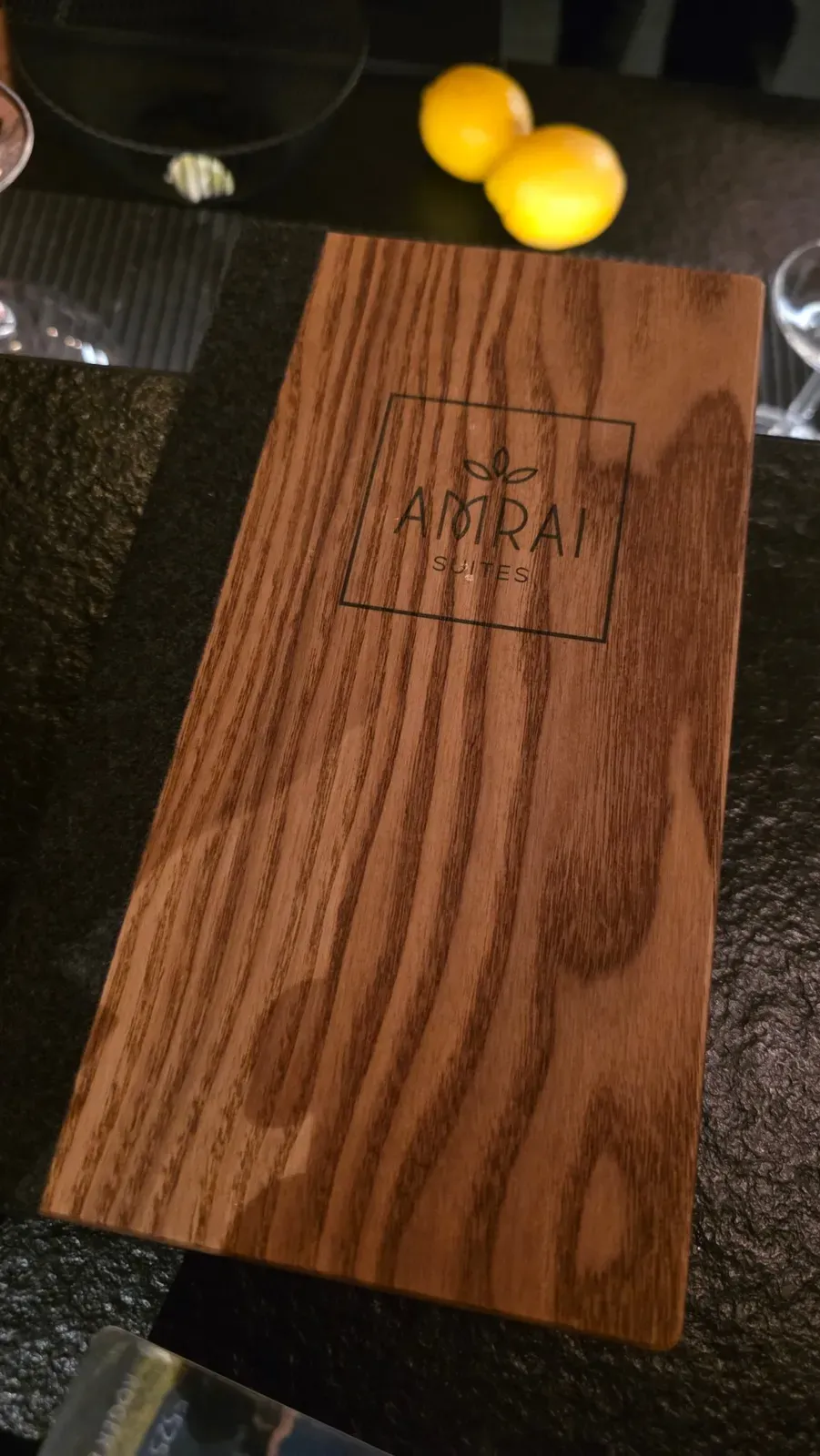 The wooden menu of the AMRAI Bar at AMRAI Suites, Schruns