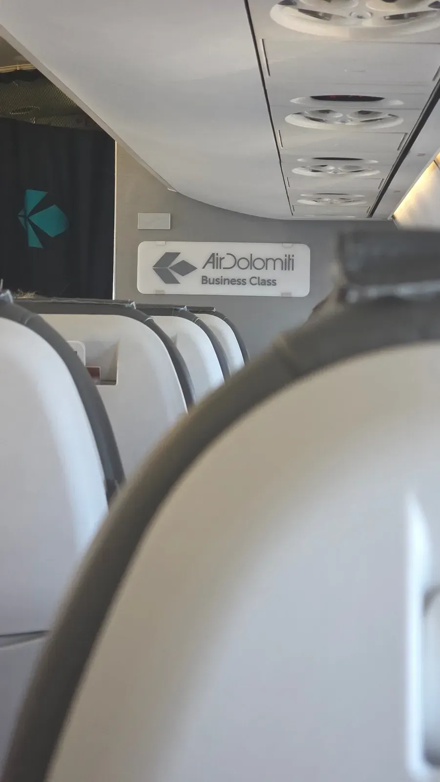 The Air Dolomiti Business Class sign at the front of the Embraer E190 cabin
