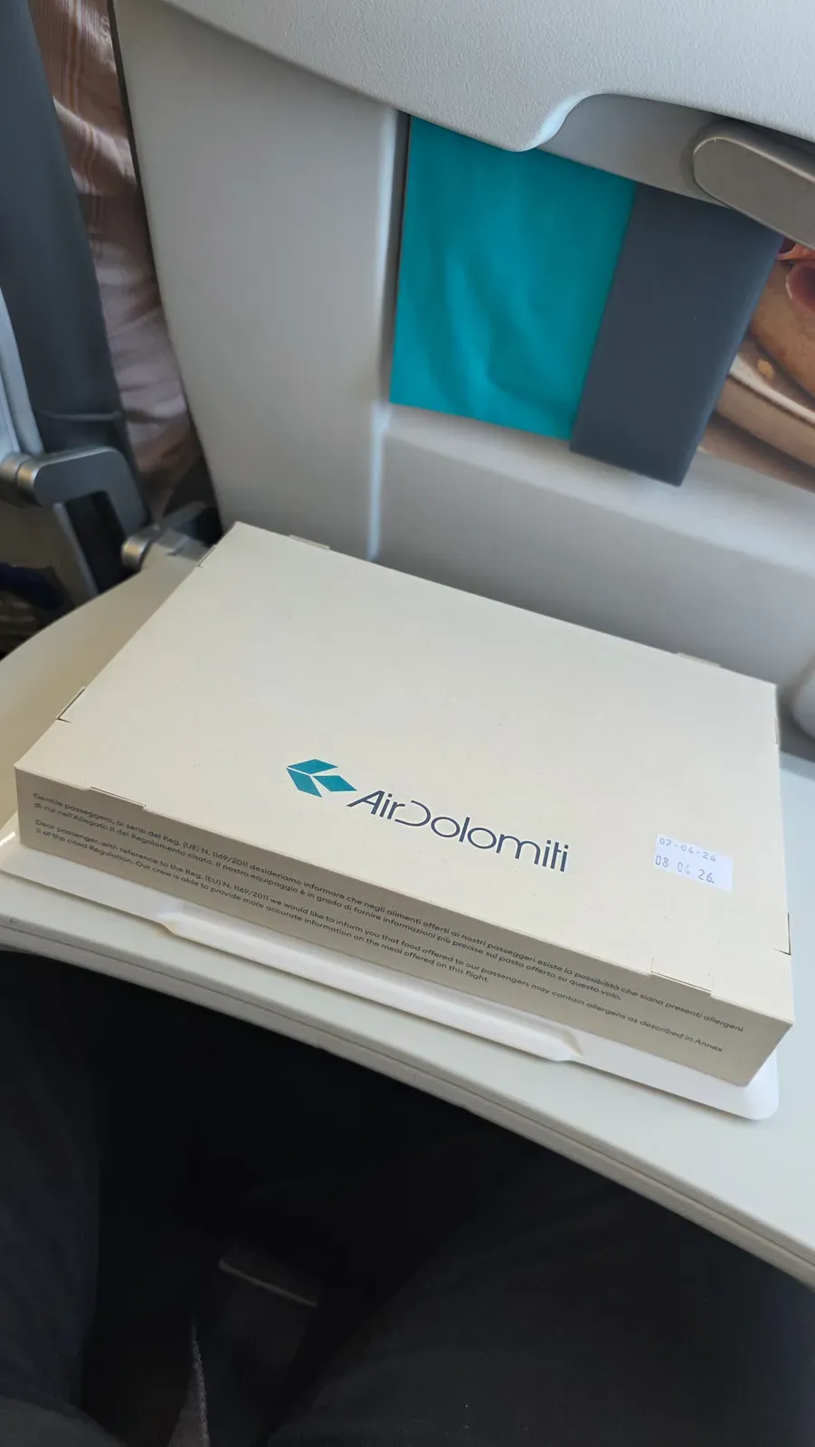 The Air Dolomiti Business Class meal box on the tray table