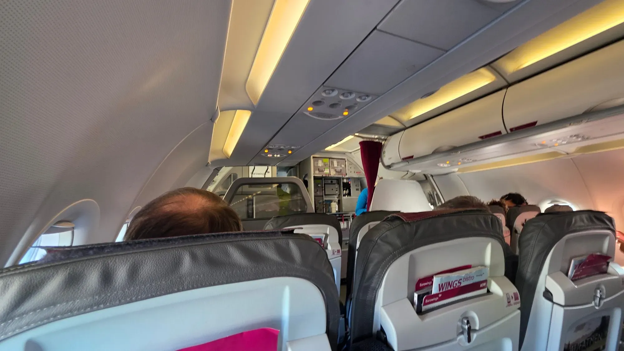 The front cabin of the Eurowings A319 with the curtain to the galley
