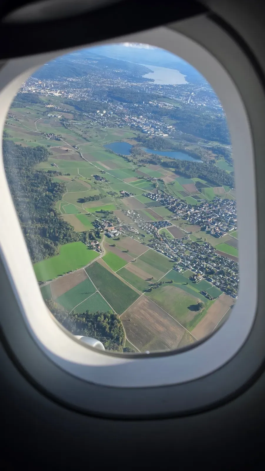 Fields and lakes north of Zurich with Lake Zurich in the distance, seen from the Eurowings A319