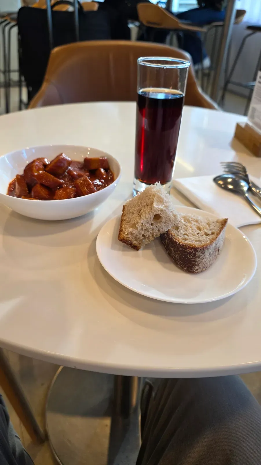 Currywurst, bread and a cola in the Lufthansa Business Lounge at Hamburg Airport