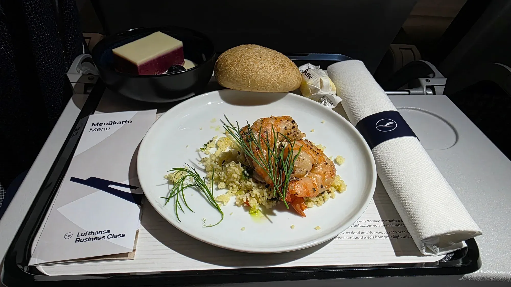 Lufthansa Business Class meal on the A321 from Munich to Hamburg: peppered shrimp confit on couscous, bread roll and blackcurrant and elderberry slice