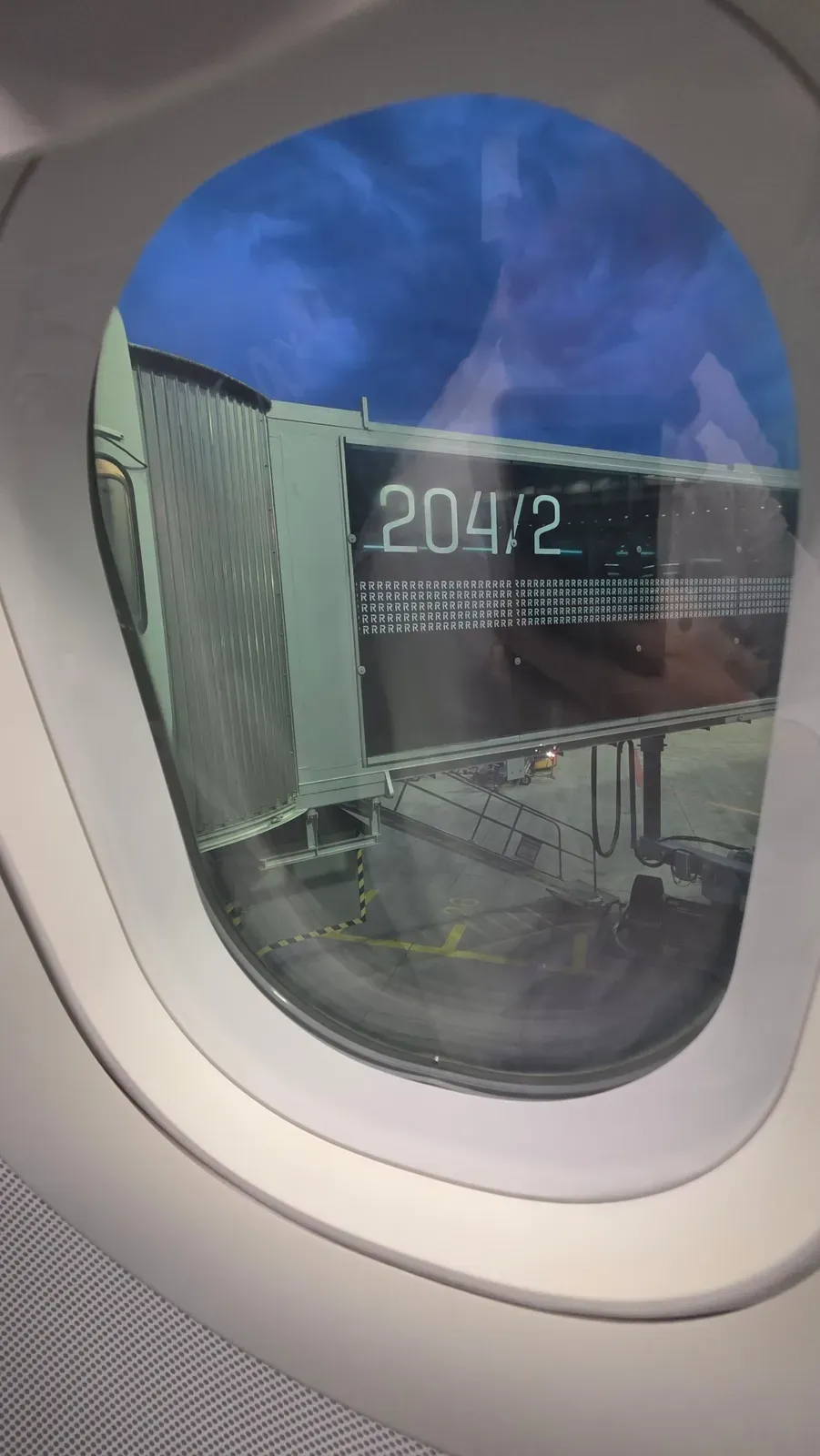 View of the jet bridge through the window of the Lufthansa A321 before departure from Munich
