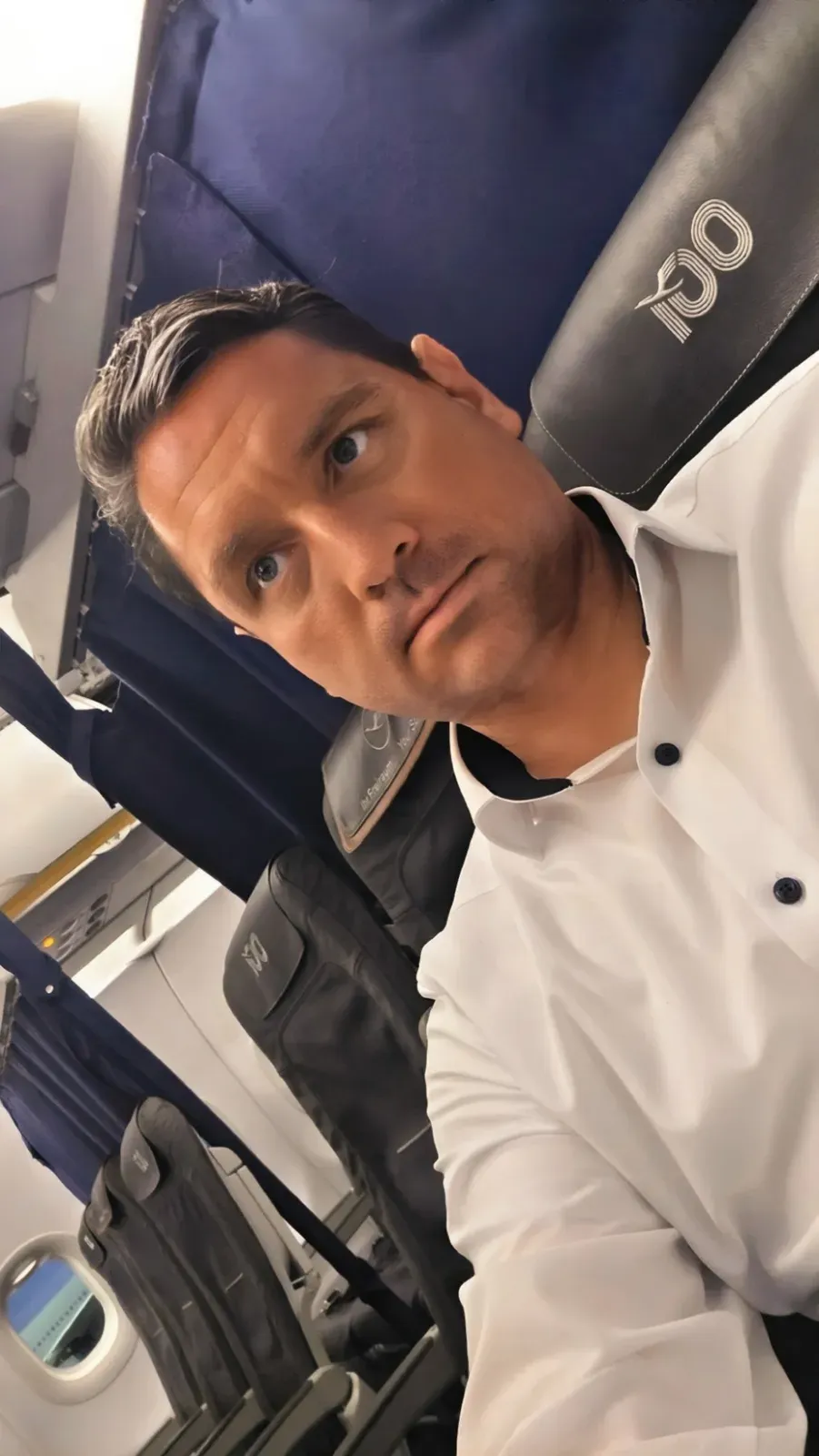 Roger Hohl in Lufthansa A321 Business Class, with the 100-year anniversary logo on the headrests