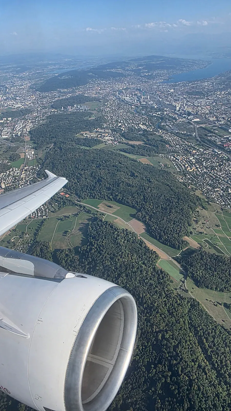 Climbing out of Zurich over forests and fields with Lake Zurich on the horizon