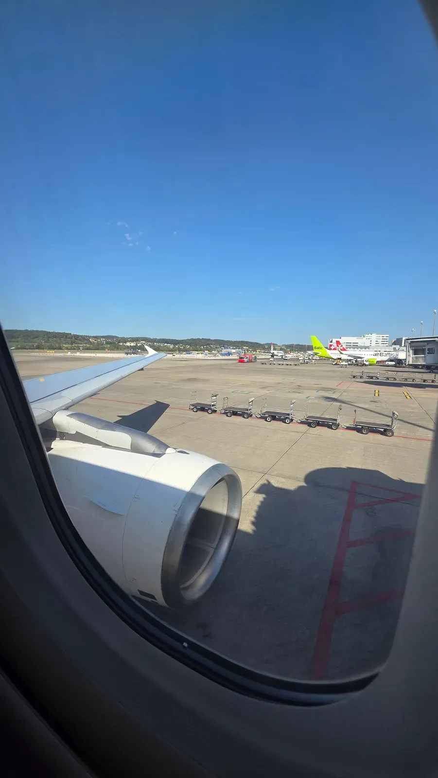 View of the wing and the apron at Zurich Airport from the SWISS A320 Business Class window seat