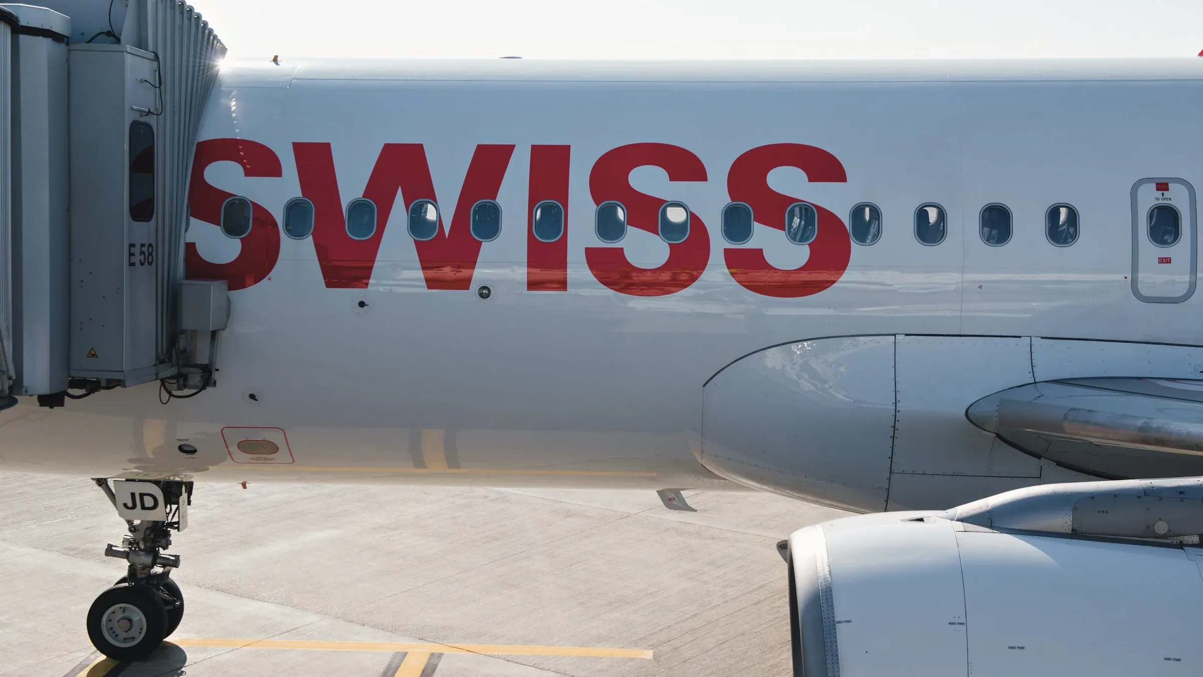 SWISS Airbus A320 at the gate with the jet bridge attached