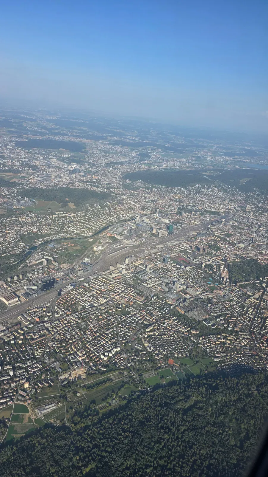 Aerial view of Zurich with the railway tracks and the city centre after take-off