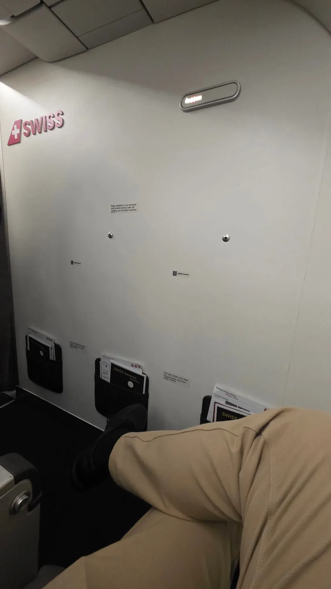 Legroom in the first row of SWISS A321 Business Class in front of the bulkhead with the SWISS logo