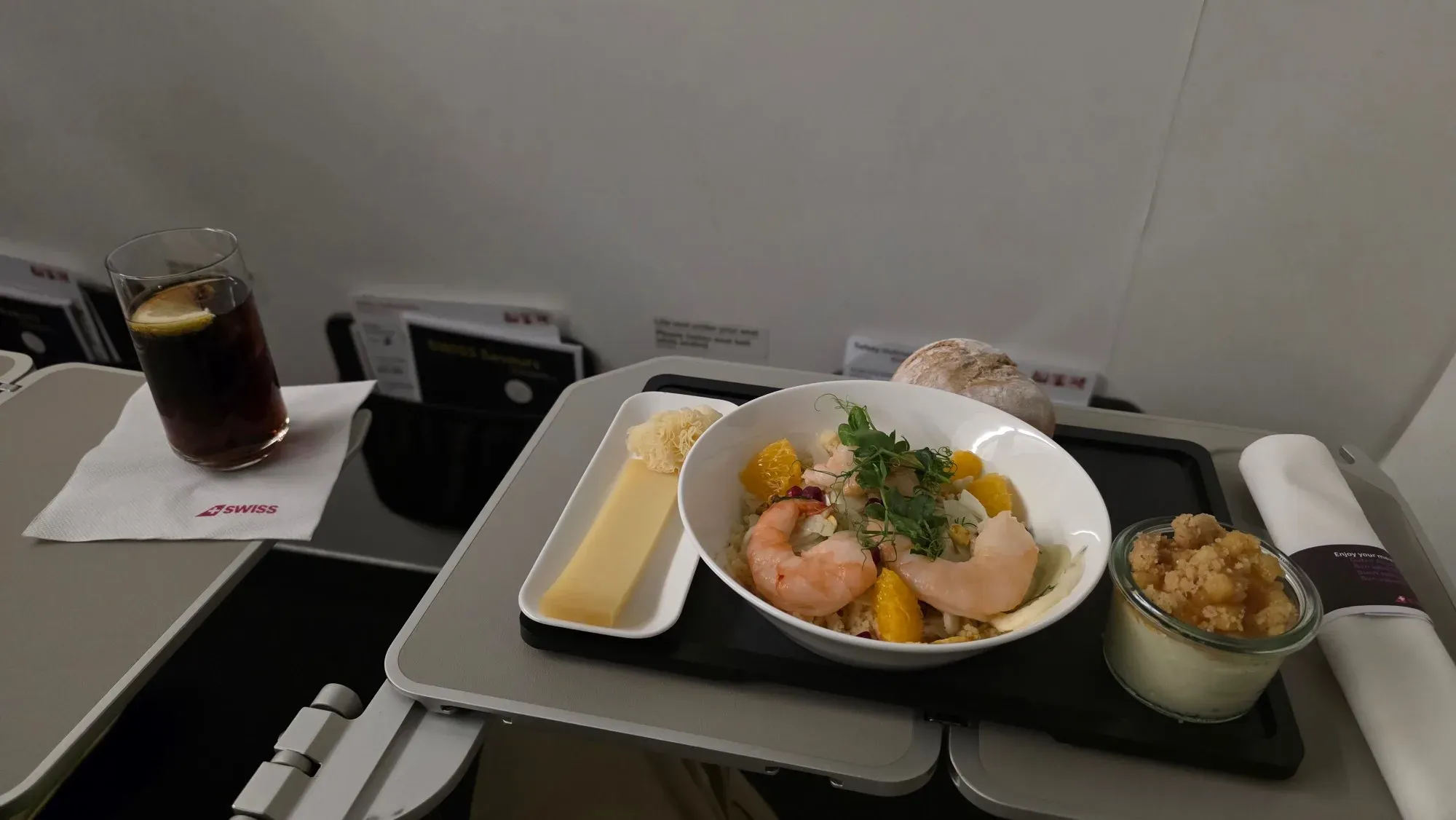 SWISS A321 Business Class meal with prawns on couscous, orange and fennel, Tête de Moine, hard cheese, a bread roll and dessert