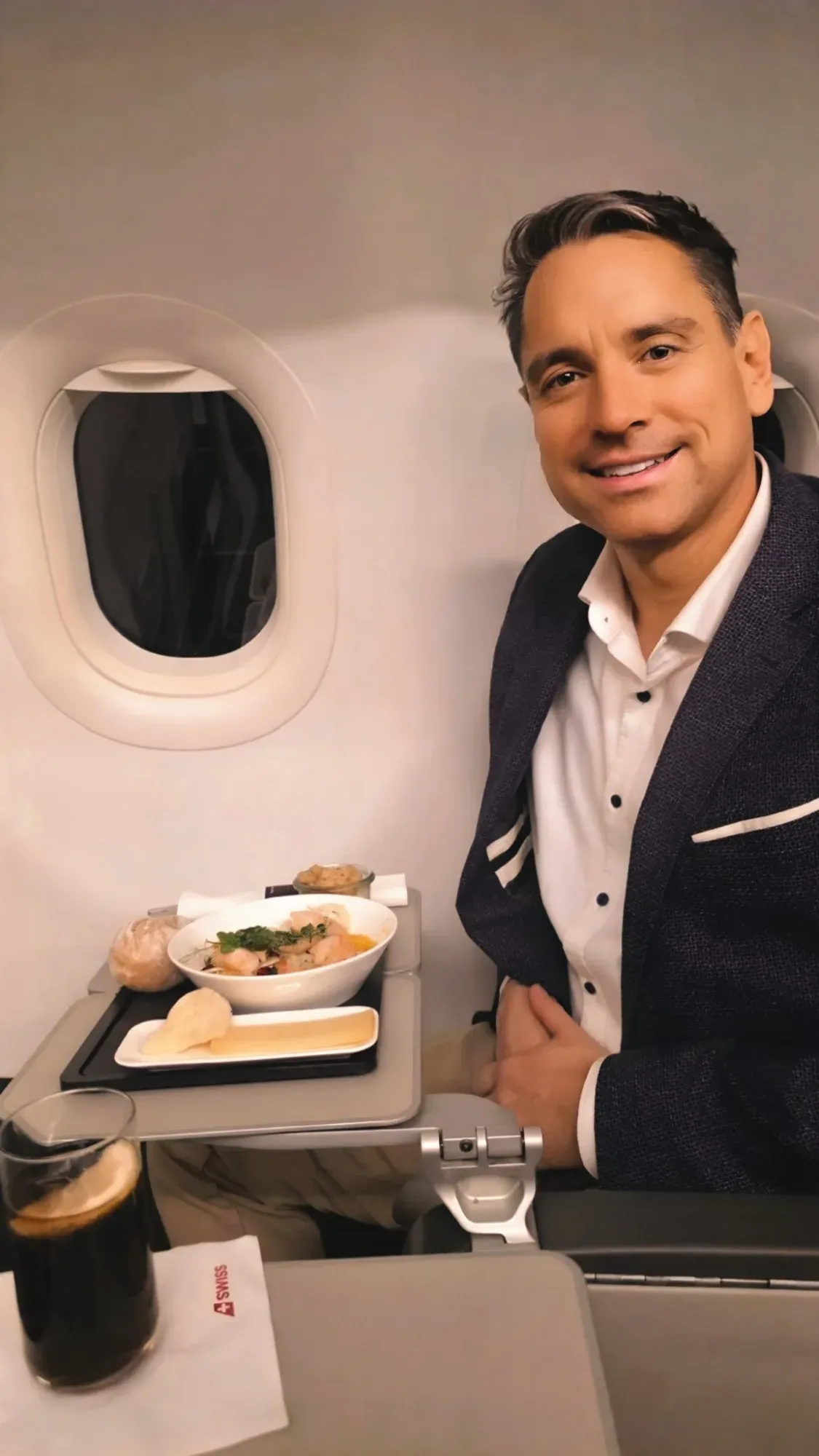 Roger Hohl at his window seat with the Business Class meal on the SWISS A321