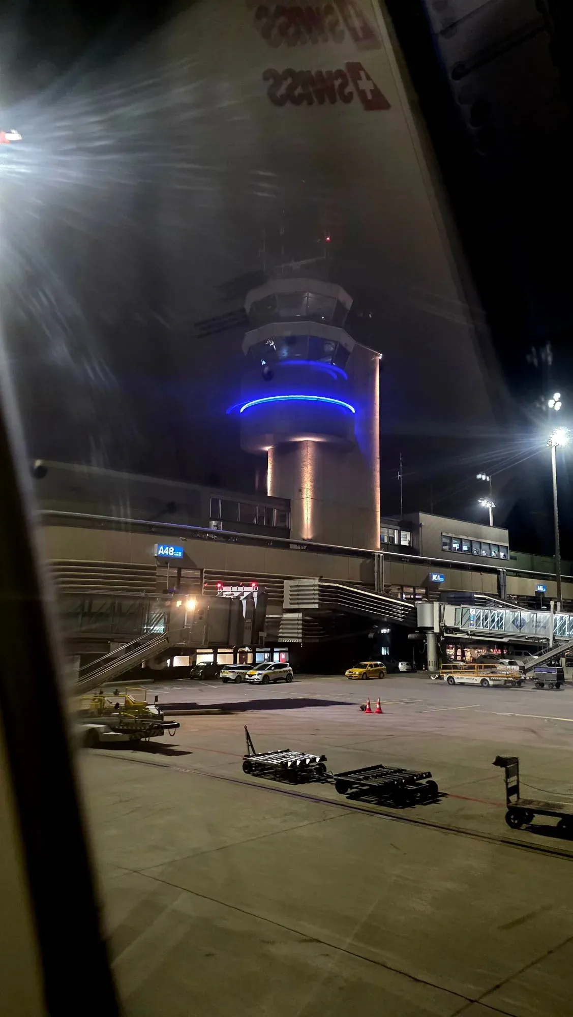 The illuminated control tower at Zurich Airport at night, seen from the SWISS A321 after landing