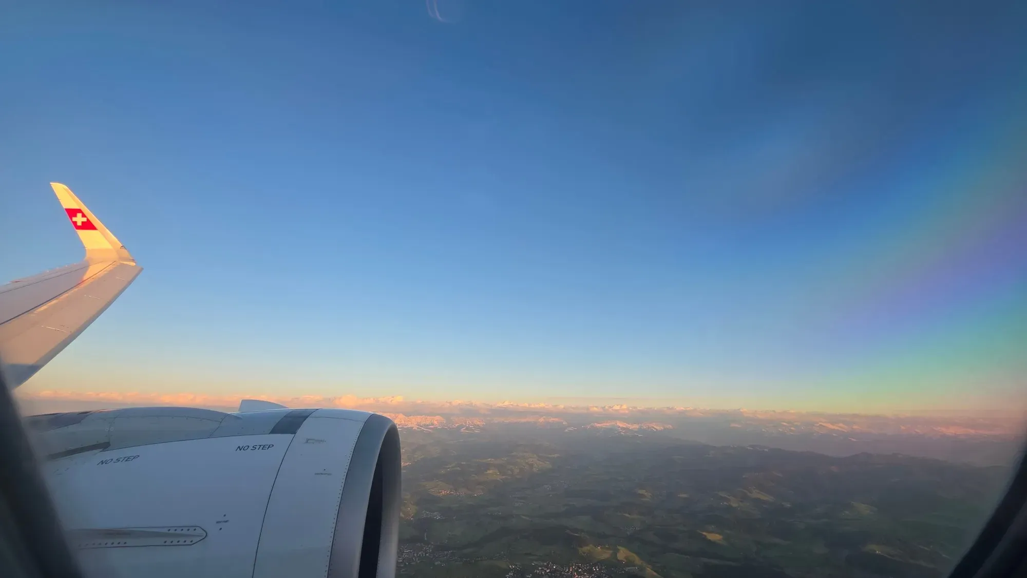 The Swiss Alps glowing in the low sun, seen from the SWISS A321neo on approach to Zurich