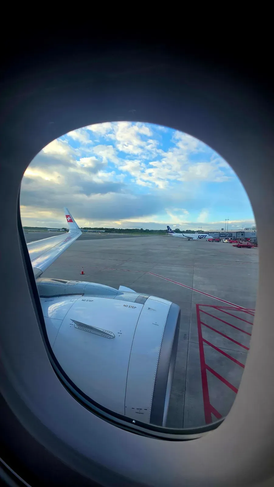 View of the wing and the apron at Hamburg Airport from the SWISS A321neo window seat