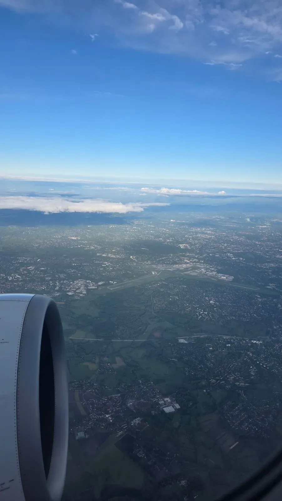 Hamburg Airport seen from above past the engine of the SWISS A321neo after take-off