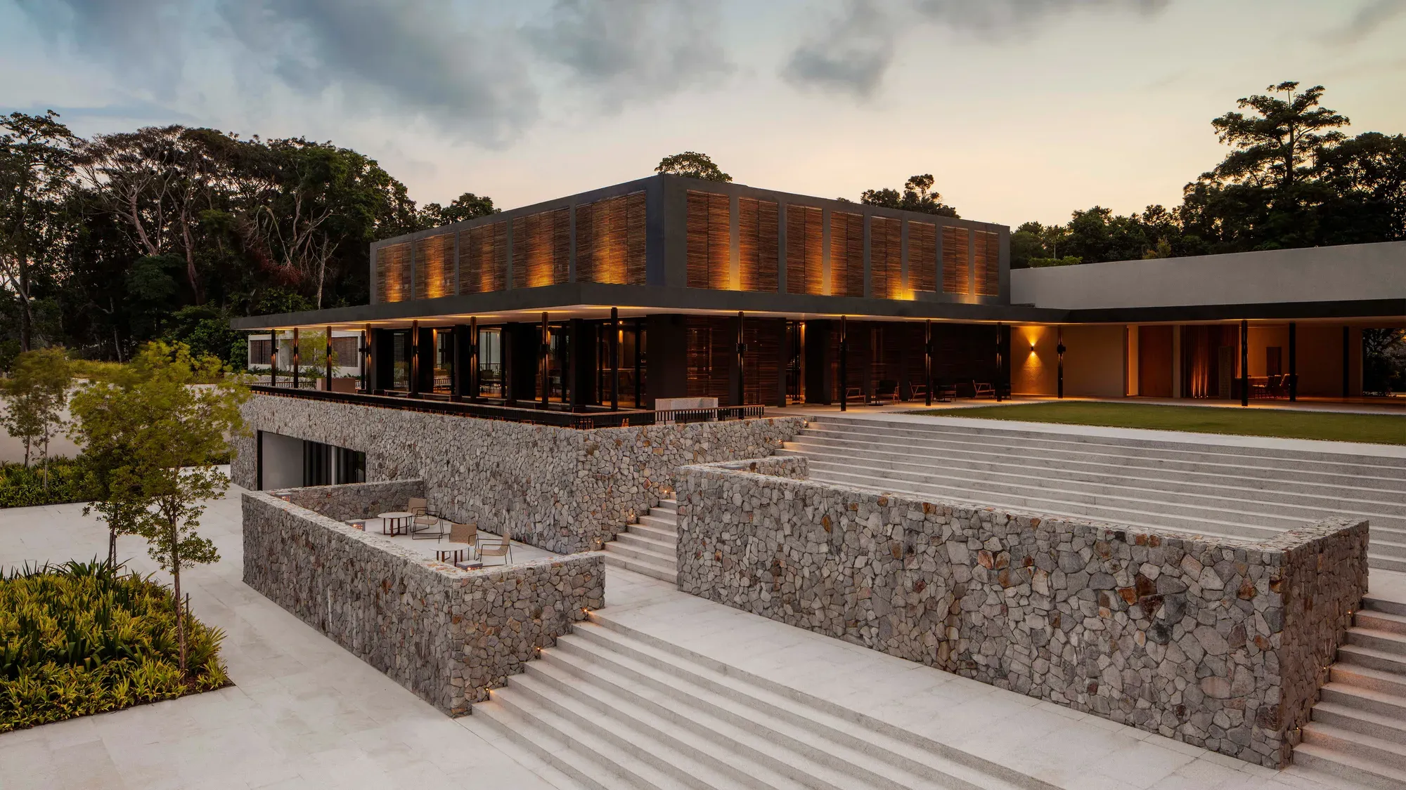 The lobby lounge of Mandarin Oriental, Desaru Coast, a low stone and glass pavilion in the rainforest