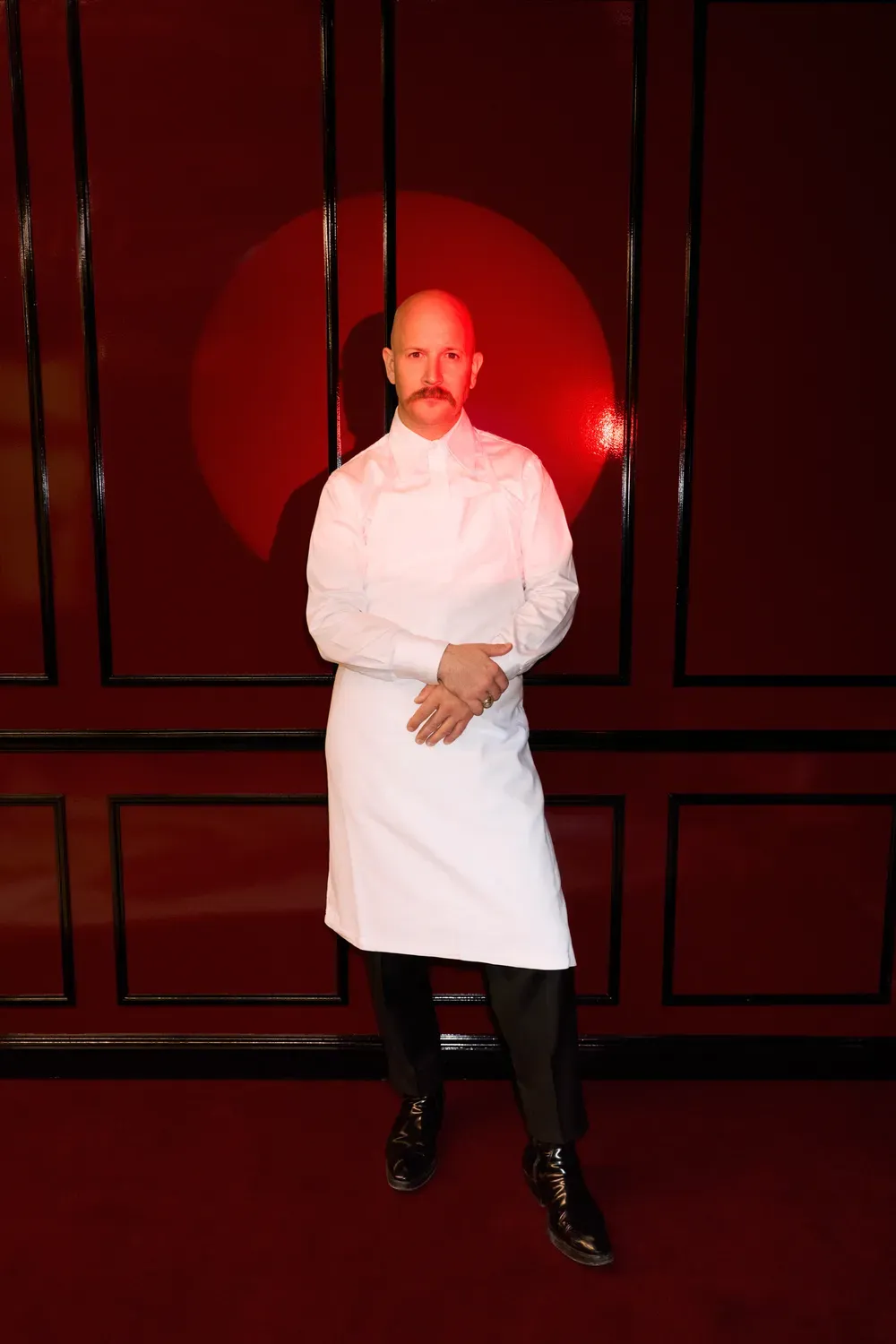 Chef Markus Stöckle in the red dining room of Marküs