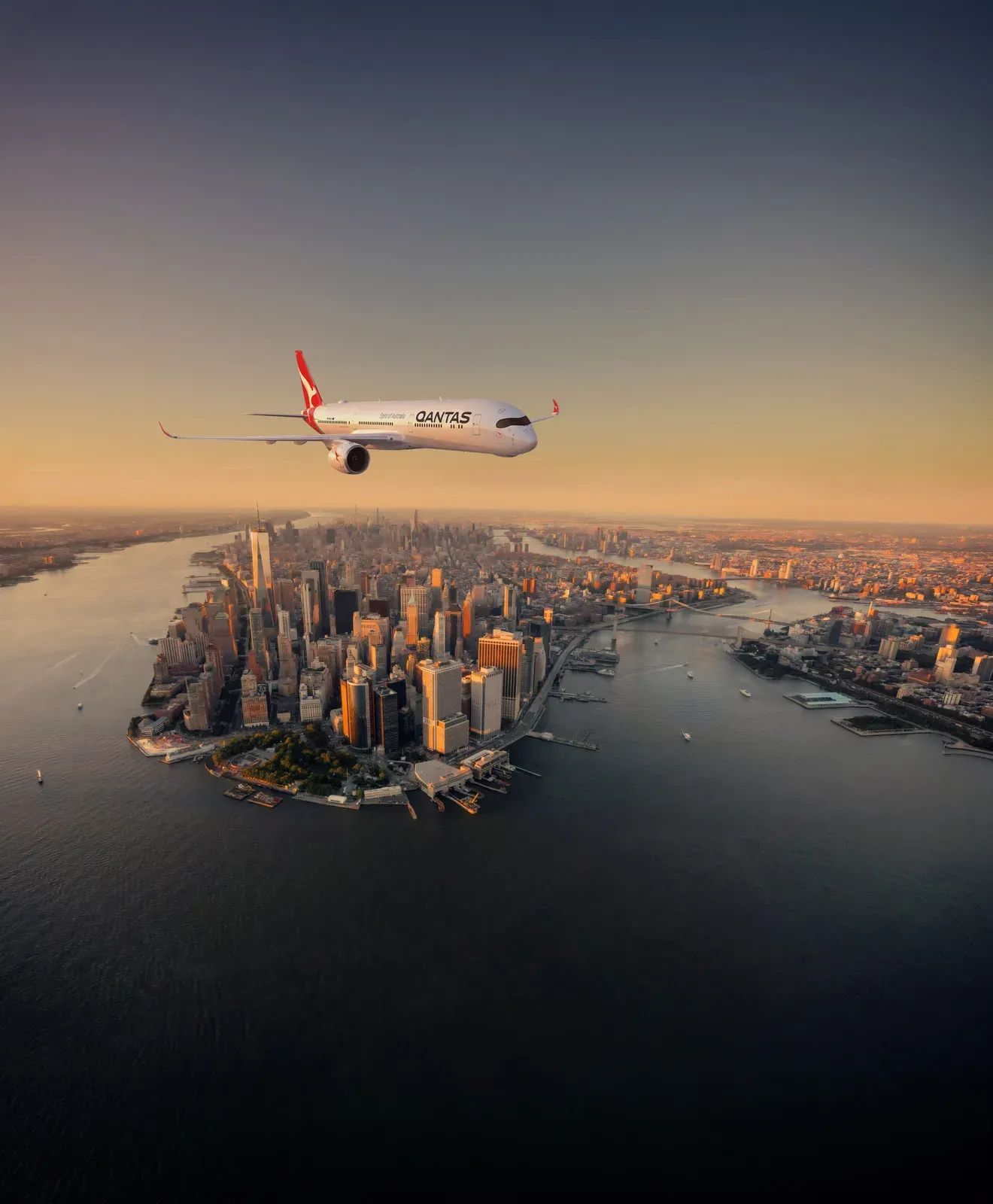 A Qantas Airbus A350-1000ULR flying over Manhattan at sunset