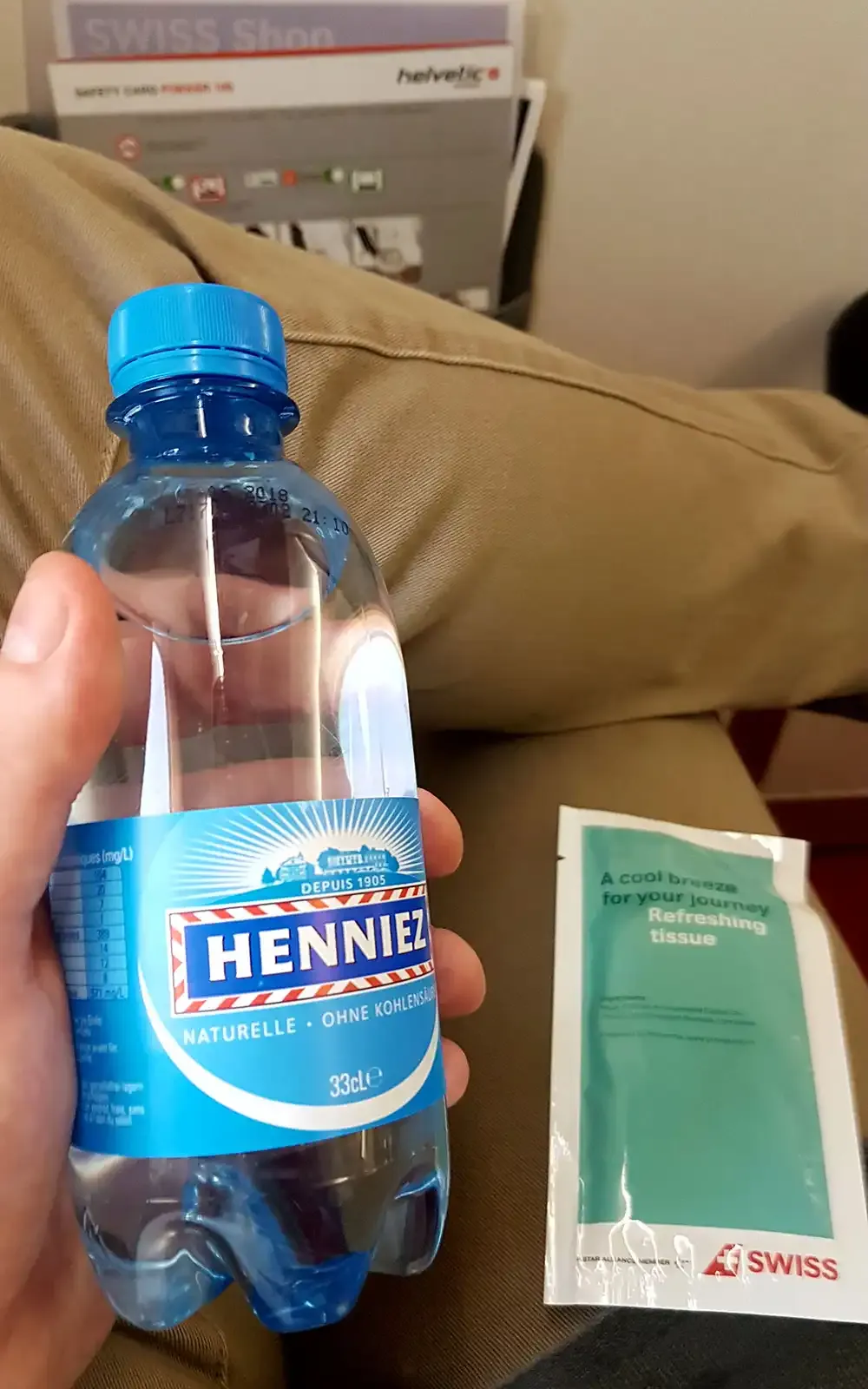 Water bottle and refreshing towel on the Helvetic Fokker 100