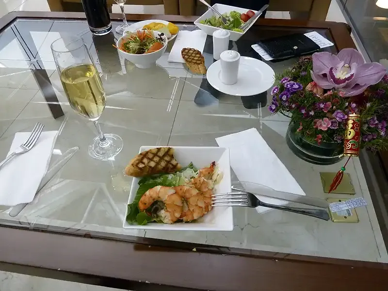 Grilled prawns and champagne in Emirates A380 First Class