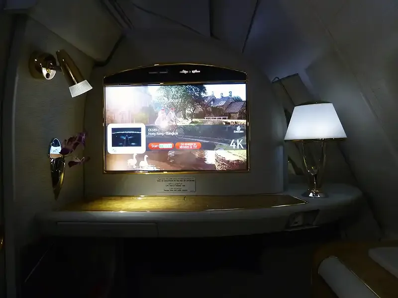 Emirates A380 First Class suite with a large entertainment screen