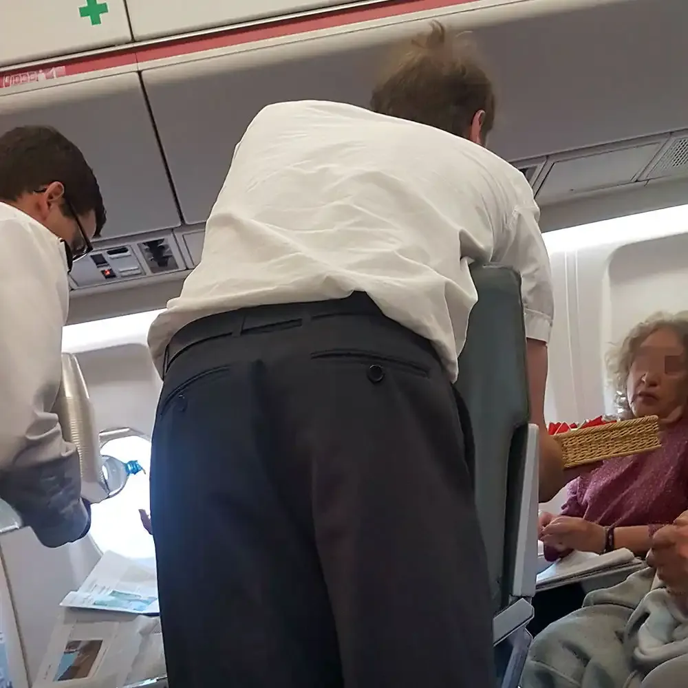 The Helvetic captain handing out chocolate in the cabin
