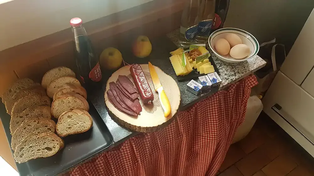 Breakfast spread with bread, cheese and sausage in the hut