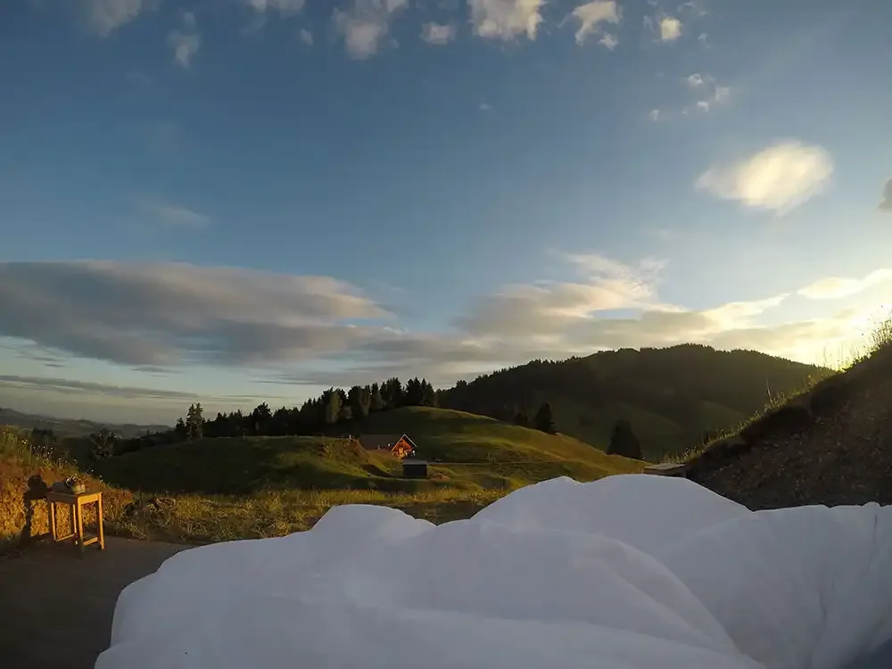Sunrise over the Appenzell hills from the open-air bed