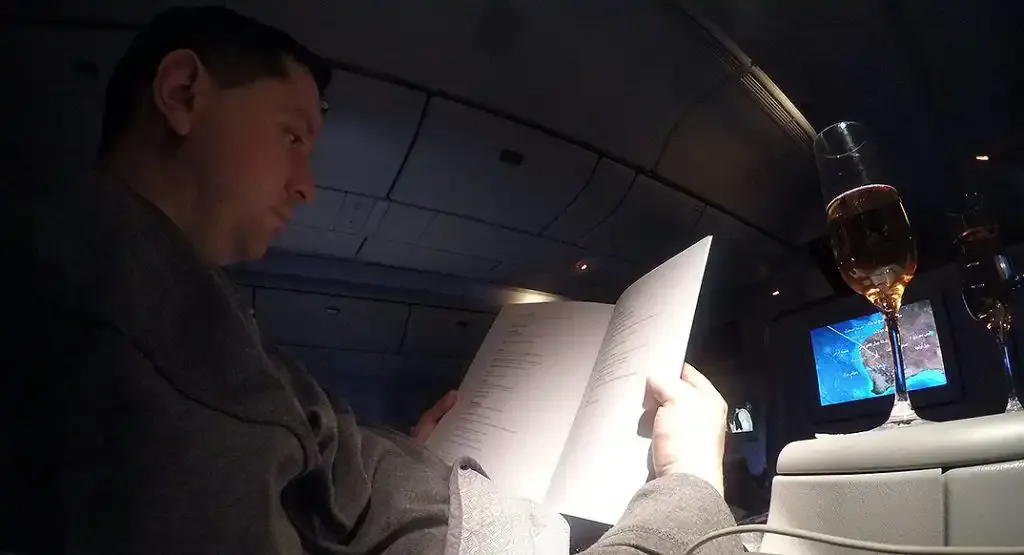 Roger Hohl reading the Qatar Airways Business Class menu
