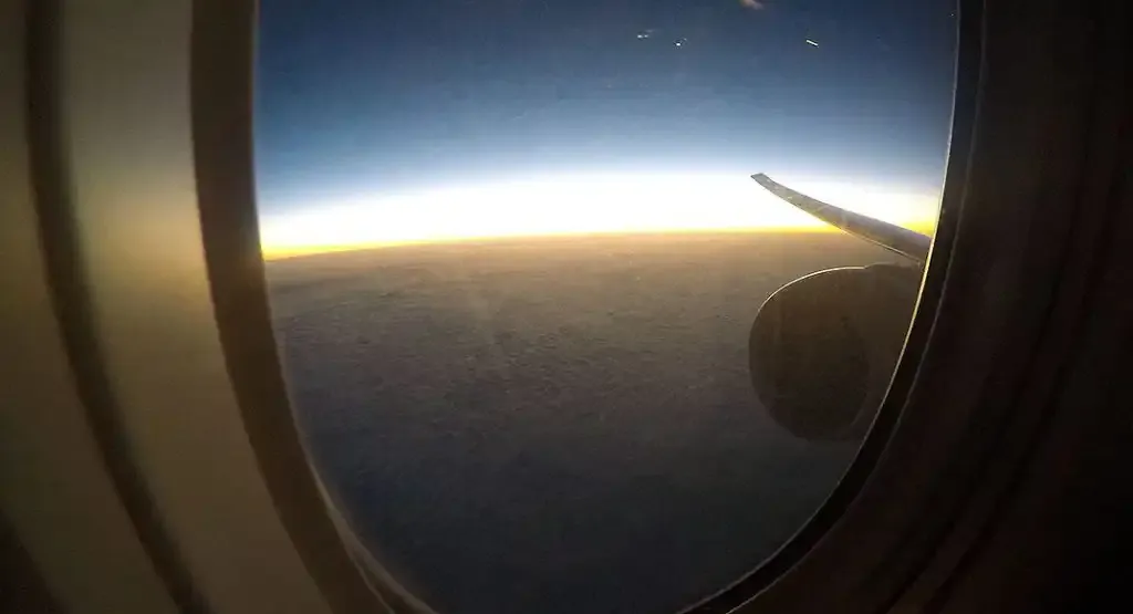 Sunrise over the wing of the Qatar Airways 777-200LR