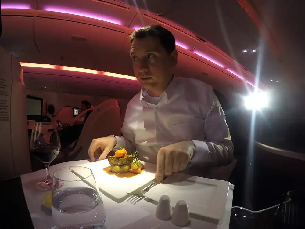 Roger Hohl eating the main course in Qatar Airways A380 Business Class