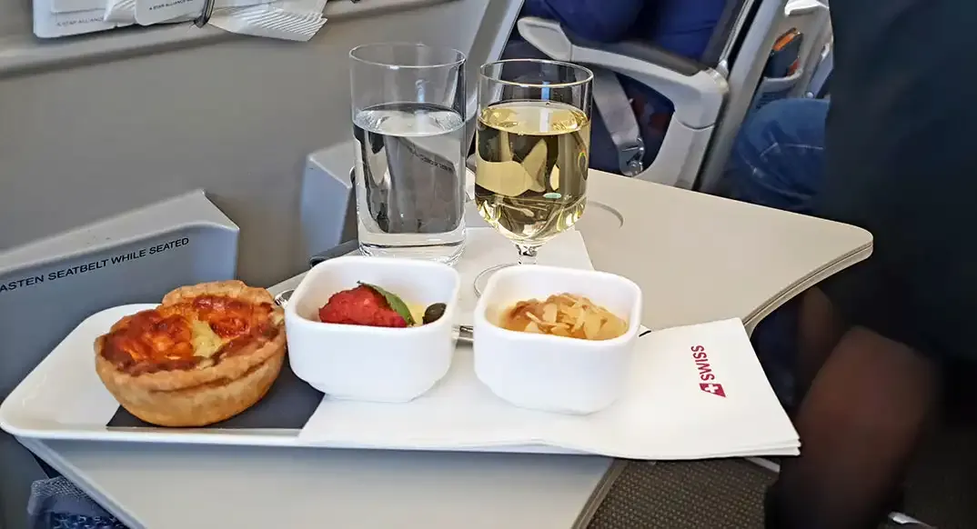 SWISS Business Class snack with quiche, fruit, water and white wine