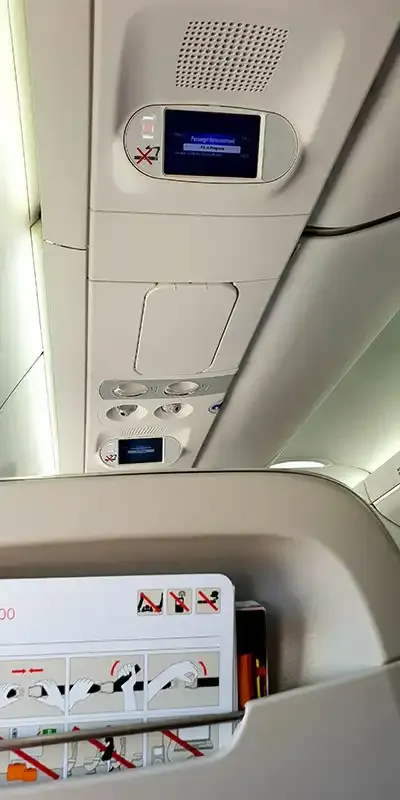 Overhead panel and seatback screen in the SWISS A220-300