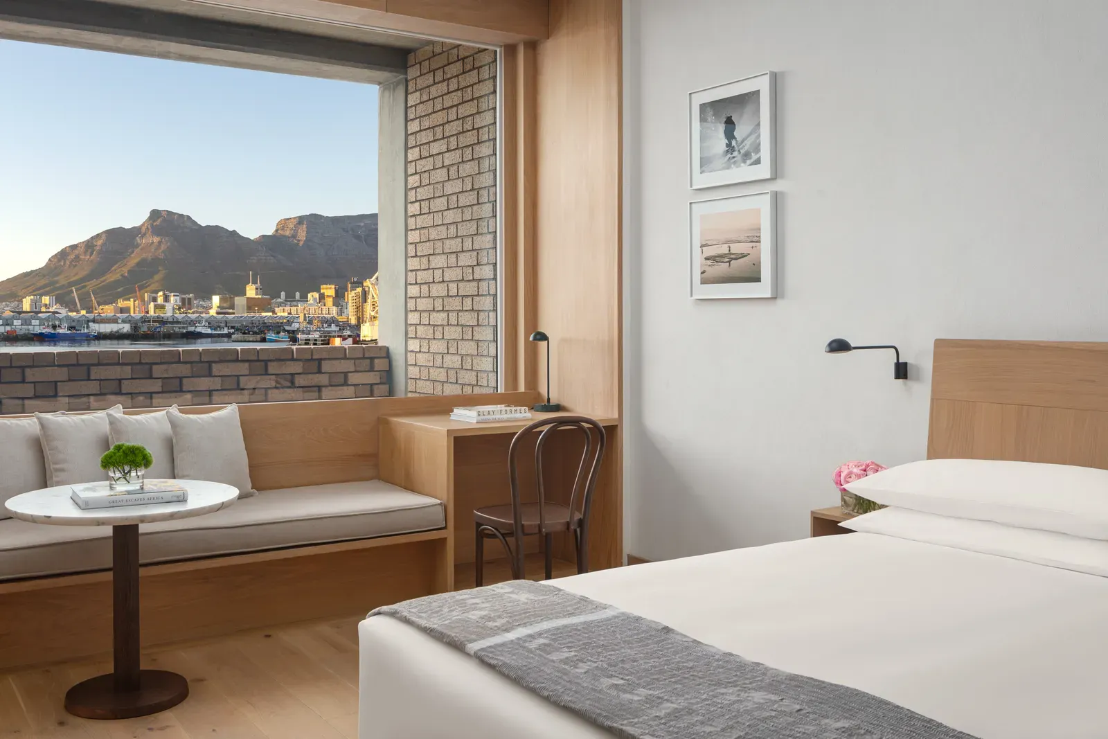 A guest room at The Cape Town EDITION with a window seat and a view of Table Mountain