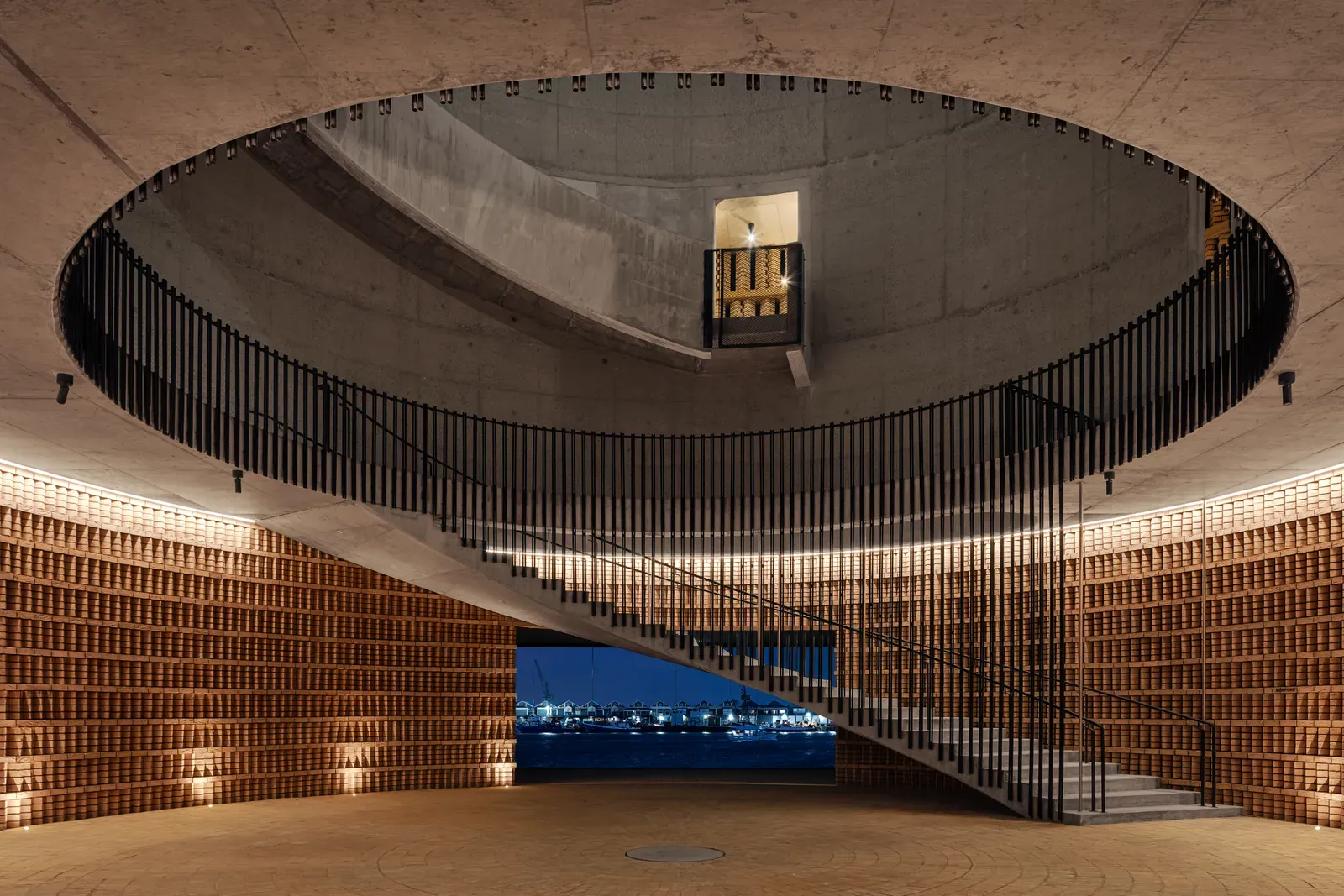 The Drum at The Cape Town EDITION, a round brick space with a spiral stair rising to an open sky